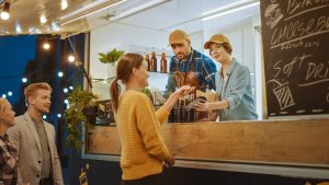 Food truck owners serving a customer