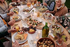 Family celebrating thanksgiving and having dinner on the dining table